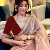 Model draped in elegant designer lace border saree at a wedding
